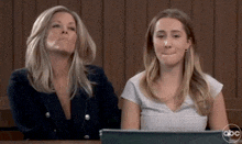 a woman and a girl are sitting at a table with a abc logo on the bottom right corner .