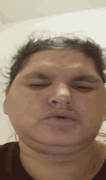 a close up of a woman 's face with her eyes closed and her mouth open .