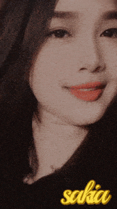 a close up of a woman 's face with the name sakia on the bottom right