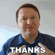 a man in a blue shirt says thanks in white letters