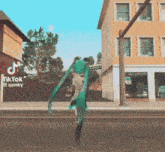a tiktok video of a person walking down a street with buildings in the background