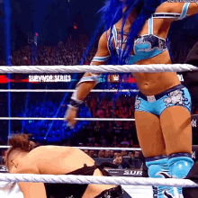 a woman in a wrestling ring with the word survivor series on the bottom