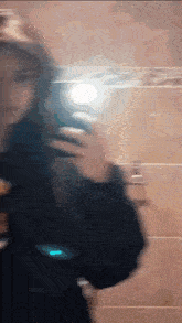 a blurry picture of a woman taking a picture of herself in a mirror