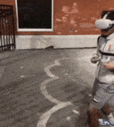 a man wearing a virtual reality headset with the letter i on his shirt