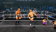 two men are wrestling in a ring with a sign that says nxt live