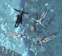 a group of women in bikinis are laying in a pool