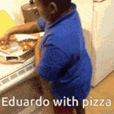 a boy in a blue shirt is standing in front of a pizza box with the words eduardo with pizza on it