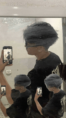 a person taking a picture of themselves in a bathroom mirror