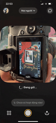 a person is taking a picture with a camera with the time 22:53 on the screen
