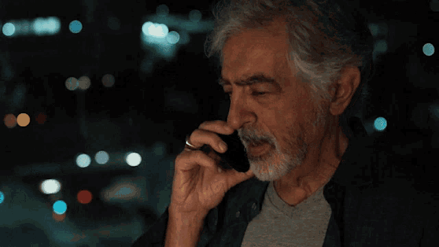 an older man talking on a cell phone with the words 