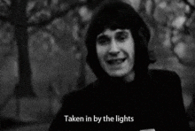 a black and white photo of a man with the words " taken in by the lights " written below him