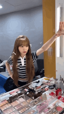 a girl with long hair is standing in front of a mirror
