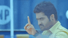 a man is pointing his finger at something in a blue background .