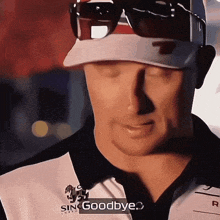 a man wearing sunglasses and a shirt that says sin goodbye on it