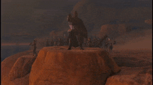 a person is standing on the edge of a cliff