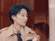 a girl with blue hair is wearing a trench coat and tie