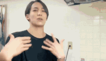 a man in a black shirt is making a funny face