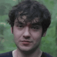 a close up of a man 's face with a smile on his face