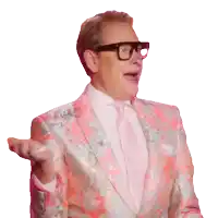 a man wearing glasses and a pink suit has his mouth open