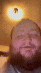 a man with a beard is making a funny face