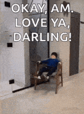 a little boy is sitting in a chair with the words okay am love ya darling