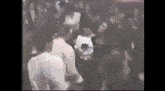 a group of people are dancing in a room in a club .