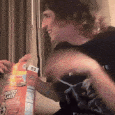 a man is holding a box of frosted flakes