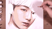a person is drawing a portrait of a young man with a pencil