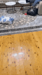a wooden floor in a living room with a rug on it