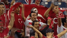 a group of people in a stadium holding a flag that says ' turkey ' on it