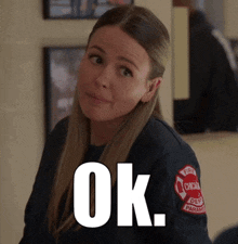 a woman is wearing a chicago fire department uniform and says ok