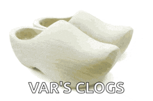 a pair of white var 's clogs on a white surface
