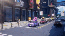 a purple car with balloons on top of it drives down a street