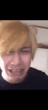 a close up of a person making a funny face with their mouth open
