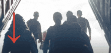 a red arrow points to a person in a crowd of people