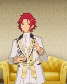 a boy with red hair is standing in front of a gold couch