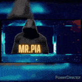 a man in a hoodie is standing in front of a blue background .