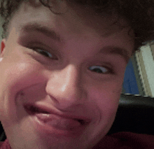 a young man is making a funny face with his tongue sticking out