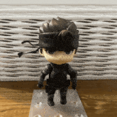 a small figurine of a man with a bandana on his head