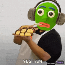a man wearing headphones and a green mask is holding a plate of tacos and smoking a cigarette ..