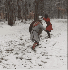 two men are standing in the snow fighting with shields