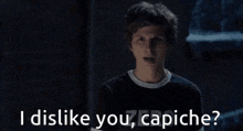 a man and a woman are standing next to each other and the man is saying `` i dislike you , capiche '' .