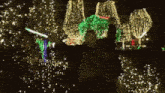 a man is holding a light saber in front of a christmas tree and trees .