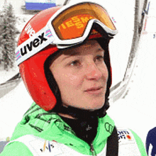a person wearing a red helmet and goggles with the word uvex on them