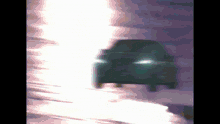 a car is driving down a road in the dark
