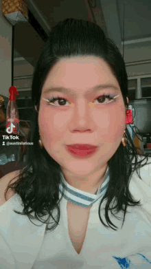 a woman 's face is shown with a tiktok sticker on it