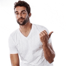 a man in a white t-shirt is pointing to the right