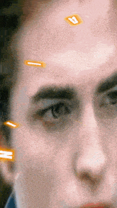 a close up of a person 's face with a letter a on his forehead