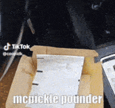 a box with a piece of paper in it that says mcpickle pounder on it