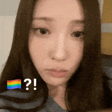 a close up of a woman 's face with a rainbow flag and a question mark above her
